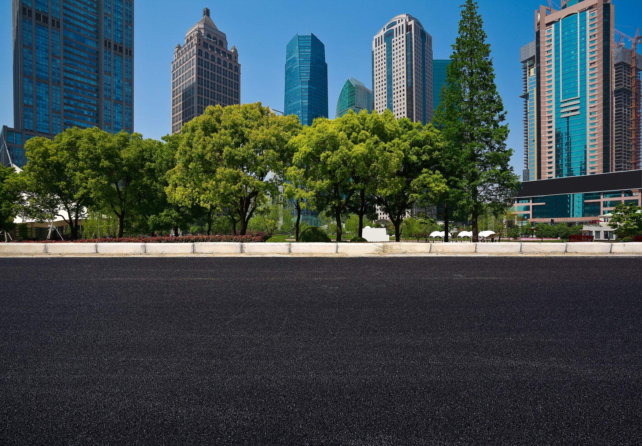 Empty road surface with modern city buildings background
